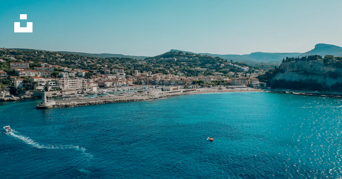 A Boat Is In The Water Near A City Photo Free Cassis Image On Unsplash a-boat-is-in-the-water-near-a-city-photo-free-cassis-image-on-unsplash