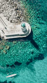 an aerial view of a boat in a body of water