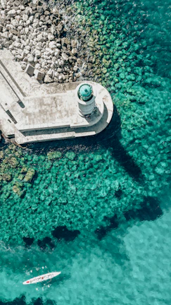 an aerial view of a boat in a body of water