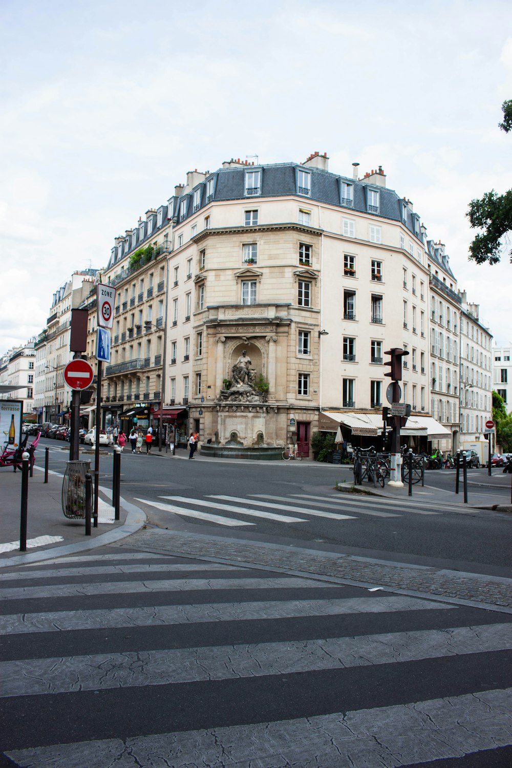 a street corner with a building in the background