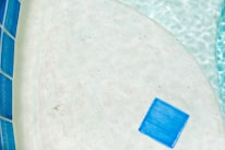 A close-up of various pool materials and tiles displayed neatly on a table.