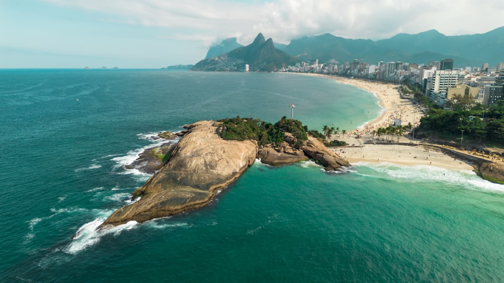 an aerial view of a beach with a city in the background