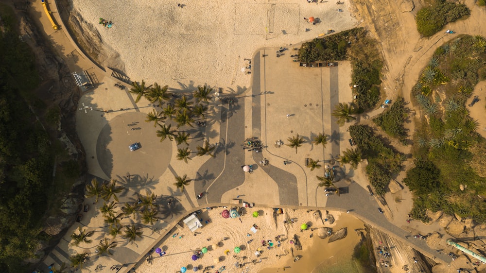 an aerial view of a sandy beach with people