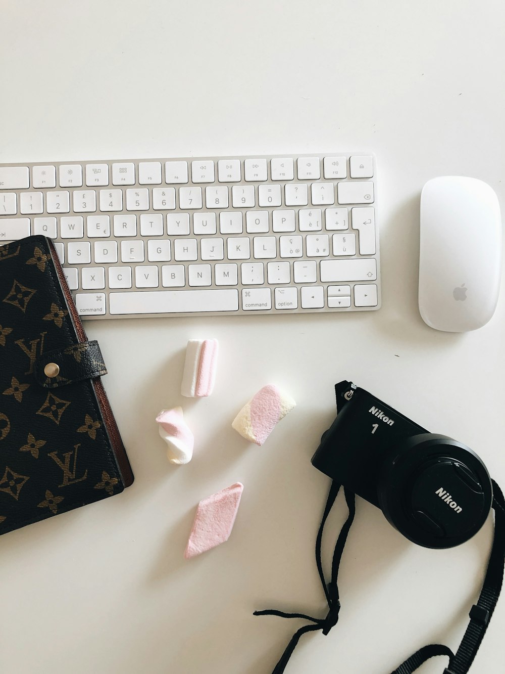 a keyboard, camera, and other items on a table