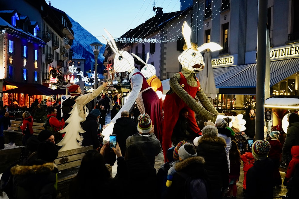 a group of people in bunny costumes walking down a street