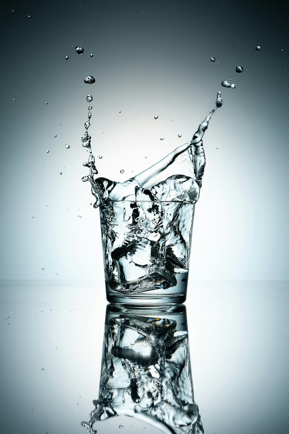 a glass filled with water on top of a table