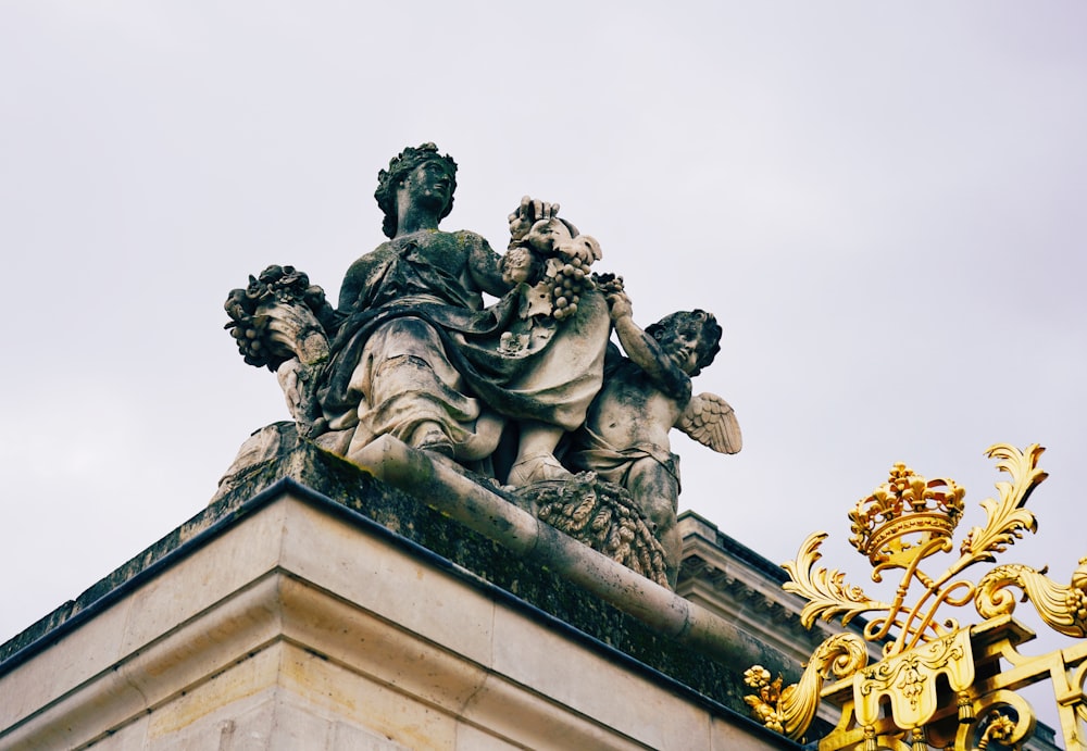 a statue on top of a building with a sky background