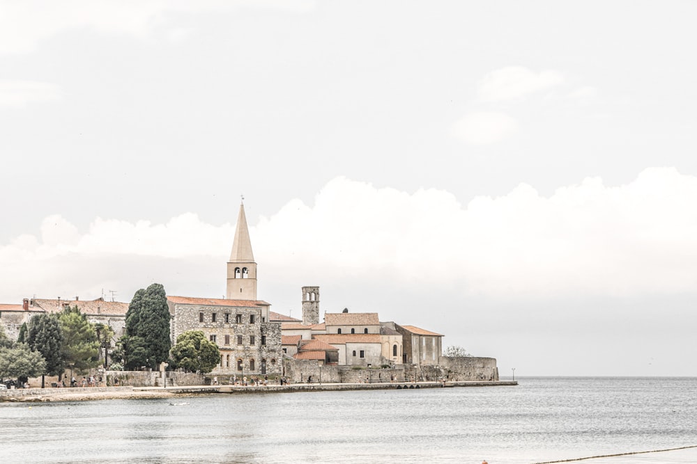 a large body of water with a small town in the background