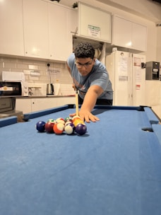 A person repairing a pool table with tools.