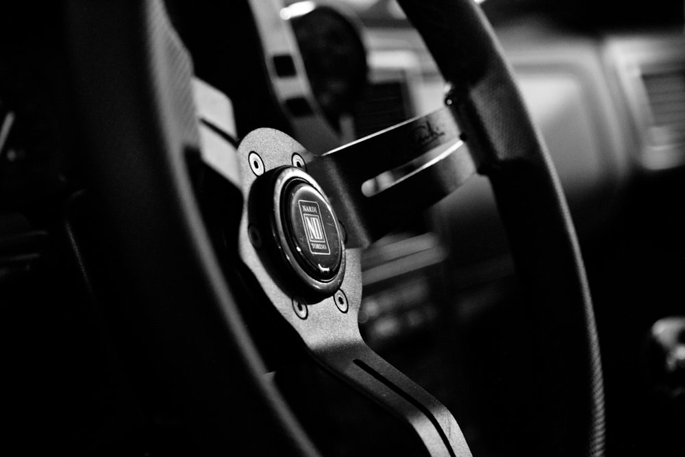 a black and white photo of a steering wheel