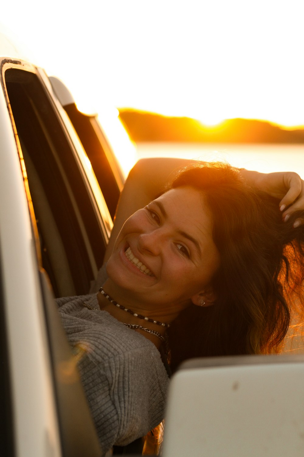 a woman leaning out the window of a car