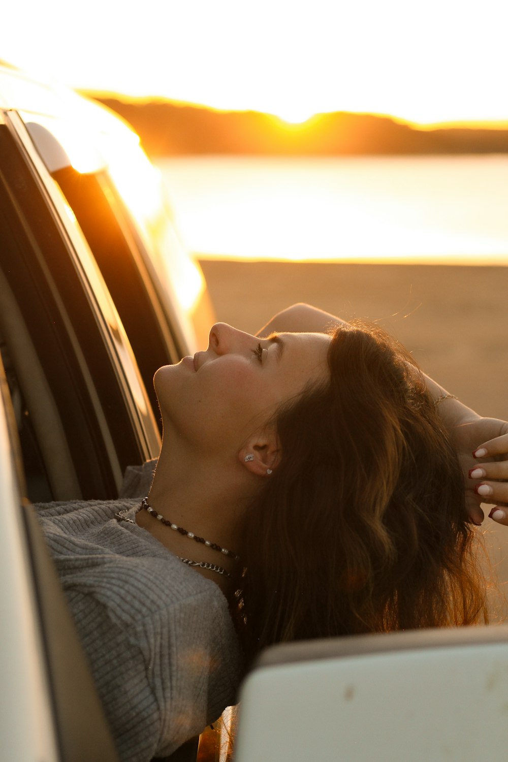 a woman leaning out the window of a car