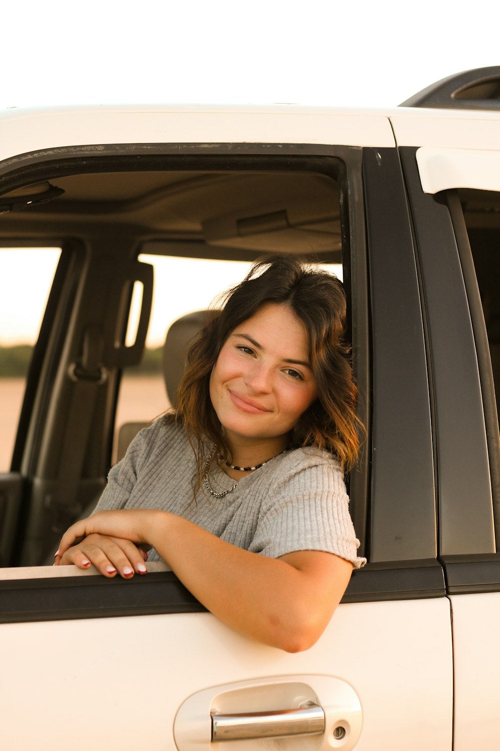 a woman sitting in the drivers seat of a truck