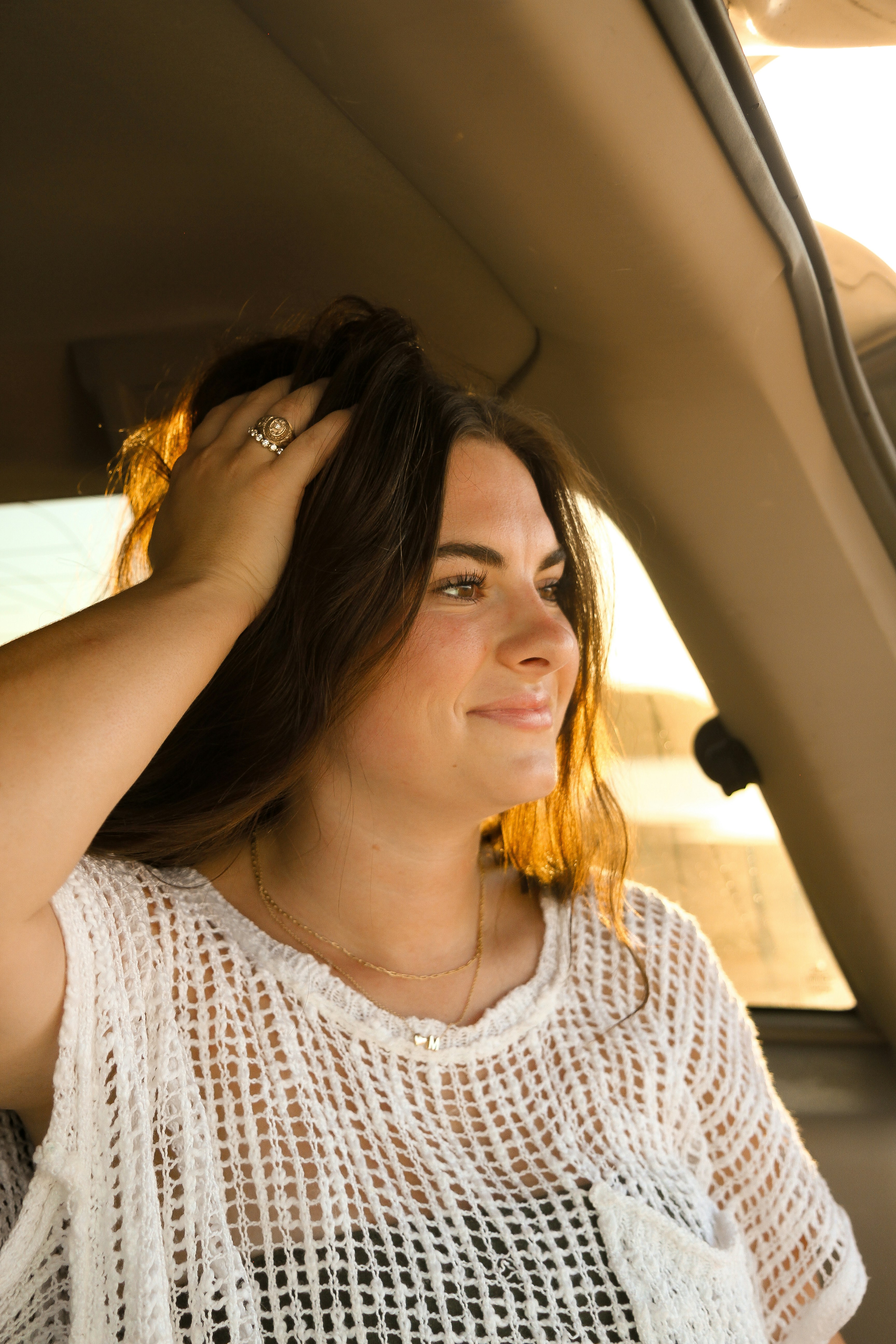 A woman sitting in the back seat of a car