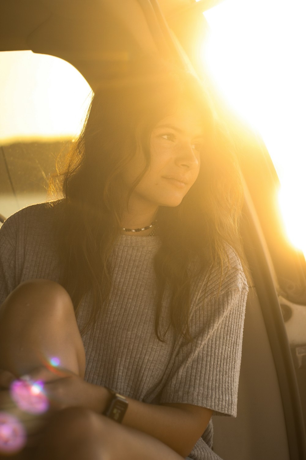 a woman sitting in the back seat of a car