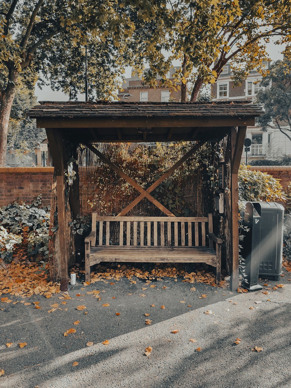 a wooden bench sitting under a tree in a park