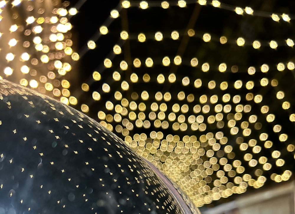 a close up of a dome with lights in the background