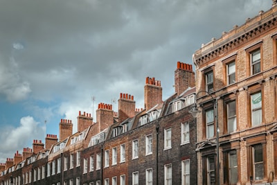a row of brick buildings on a cloudy day