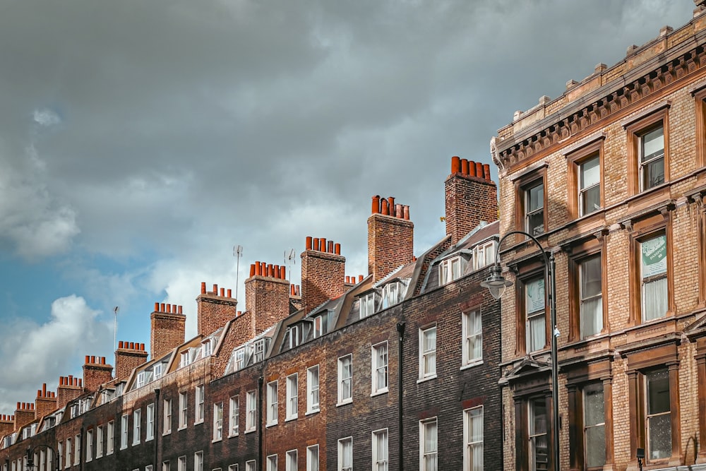 a row of brick buildings on a cloudy day