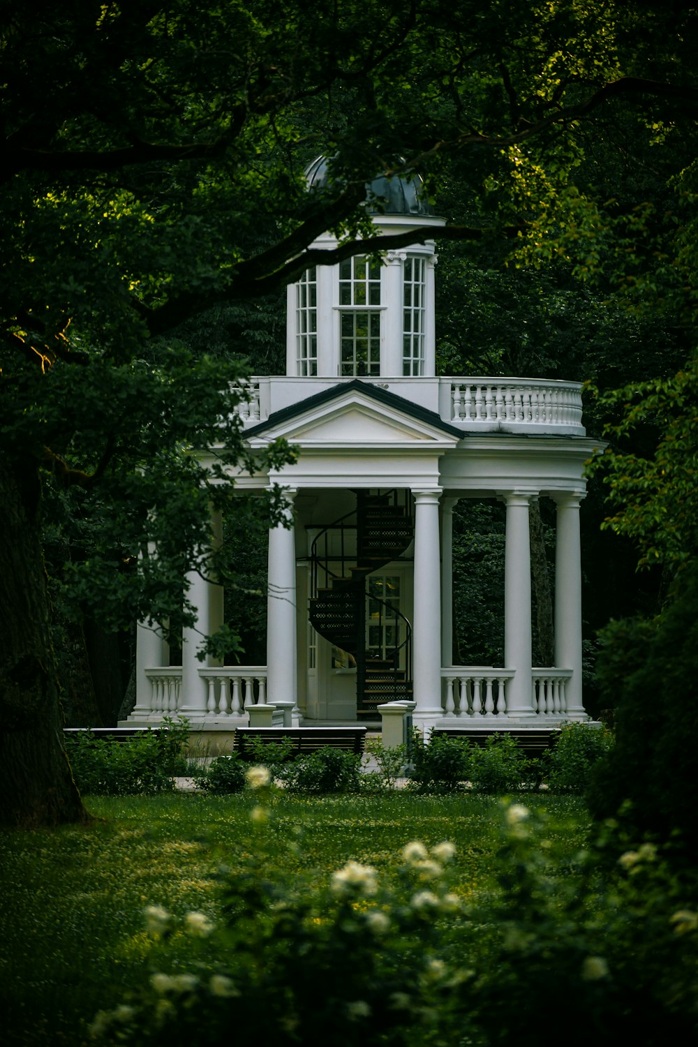 a white house with a clock tower on top of it