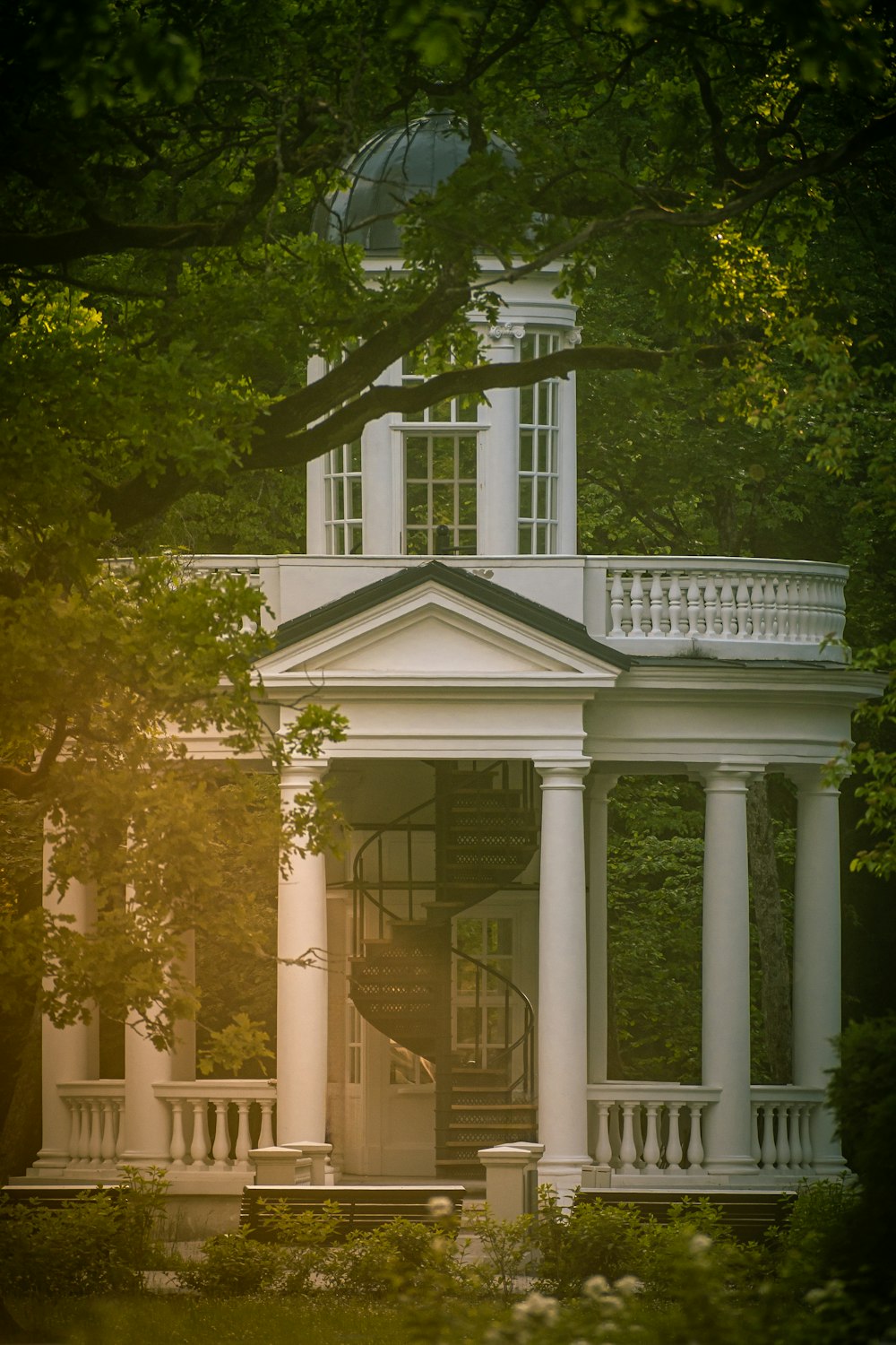 a large white house with a clock tower