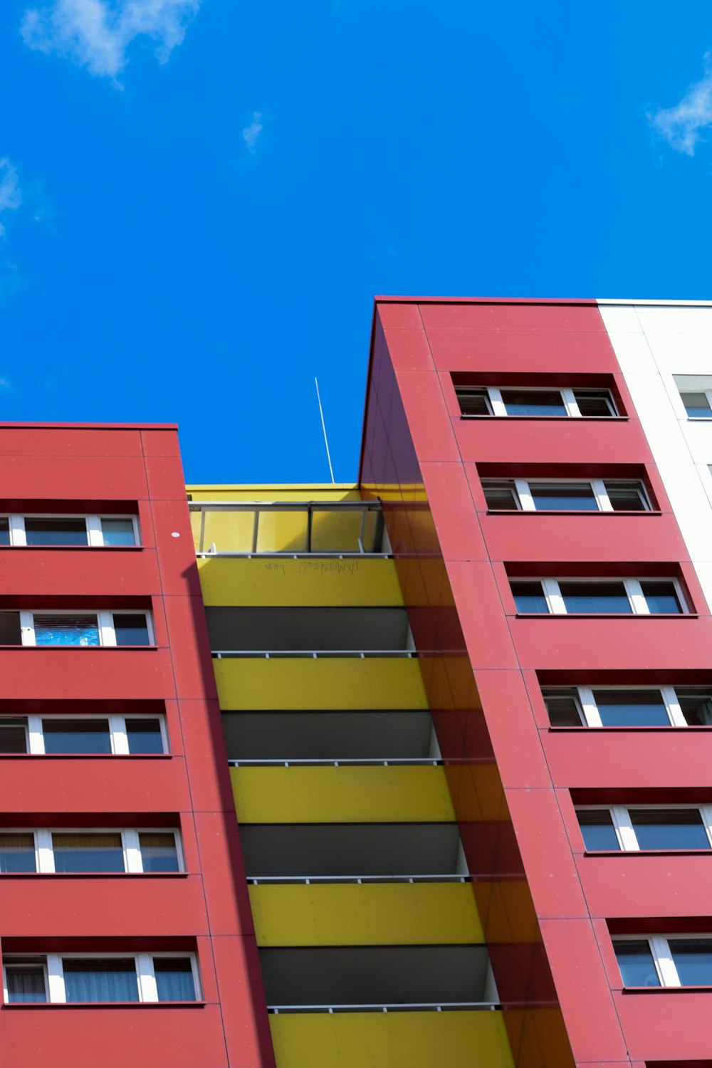 a red and yellow building against a blue sky