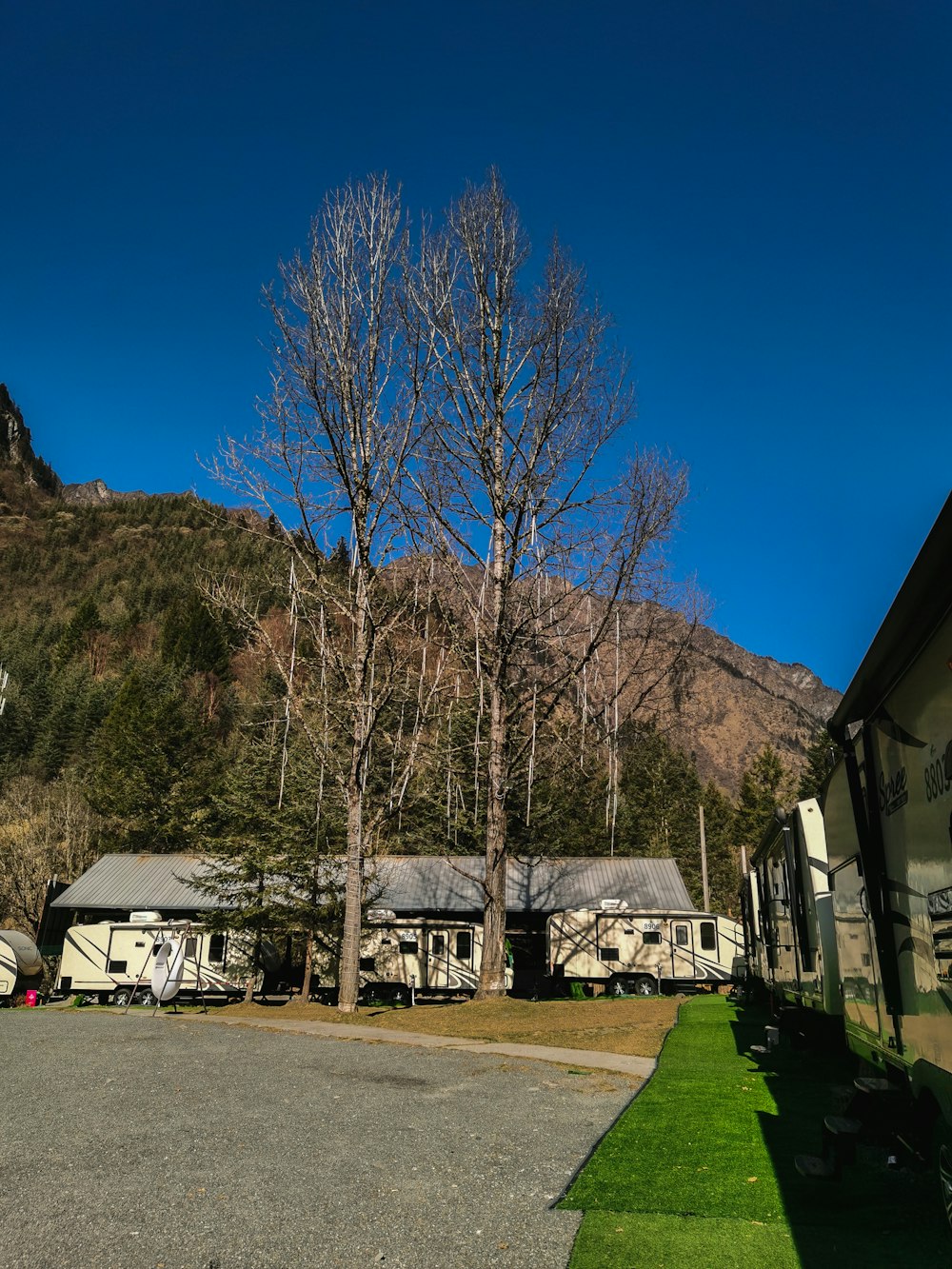 a group of rvs parked in front of a mountain