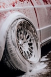 a white car with red writing on the side of it