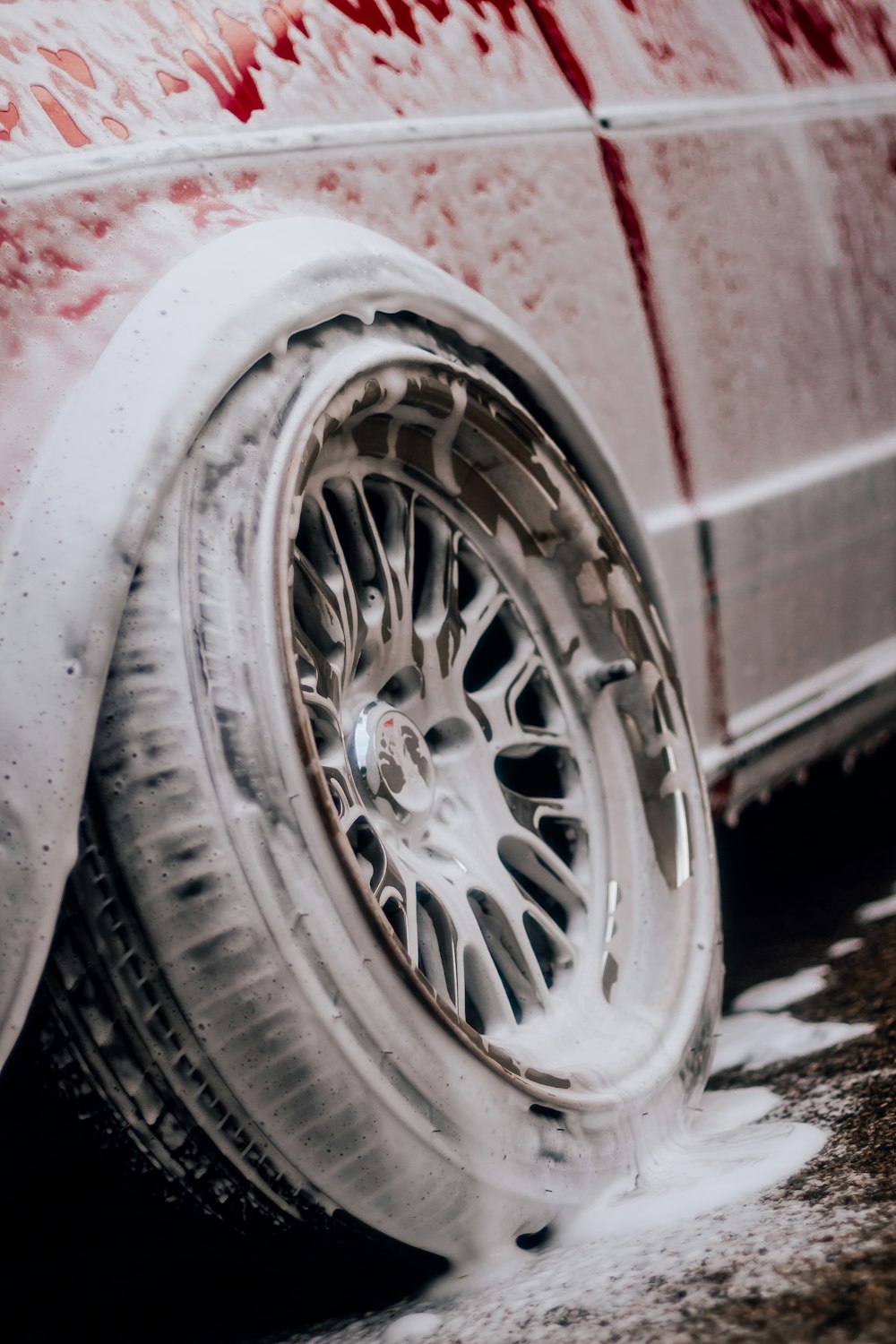 a white car with red writing on the side of it