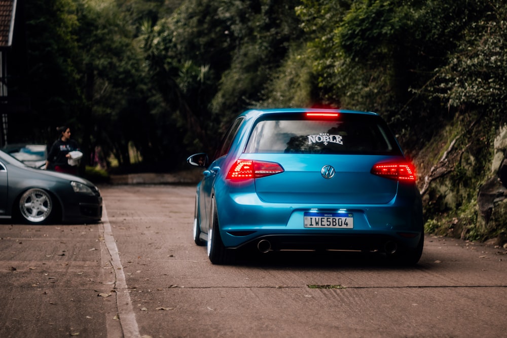 a blue car parked on the side of a road