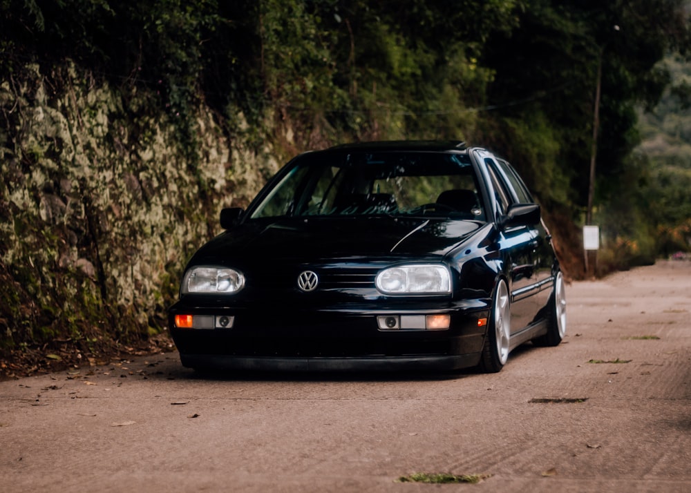 a black car parked on the side of a road