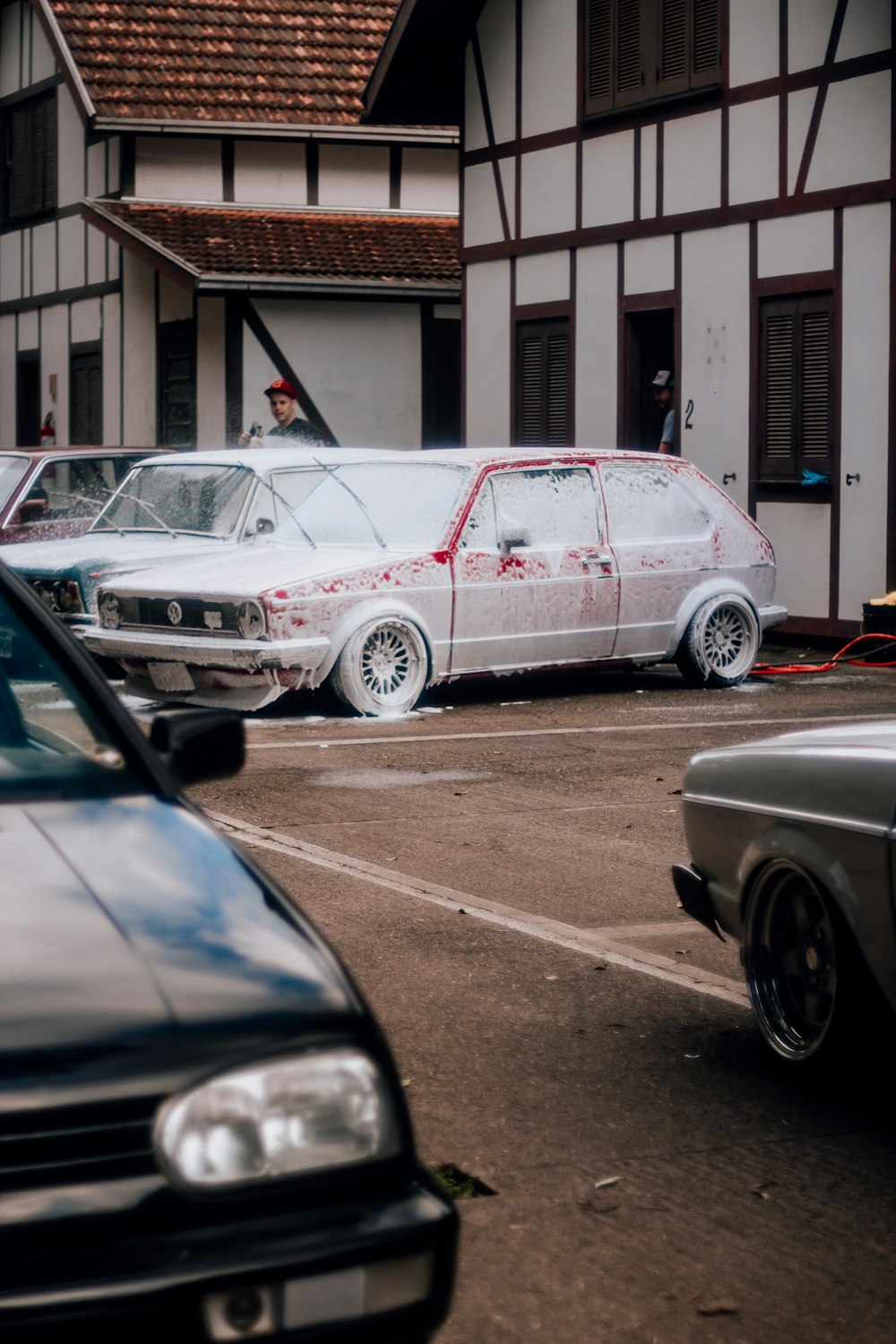 a group of cars parked next to each other in a parking lot