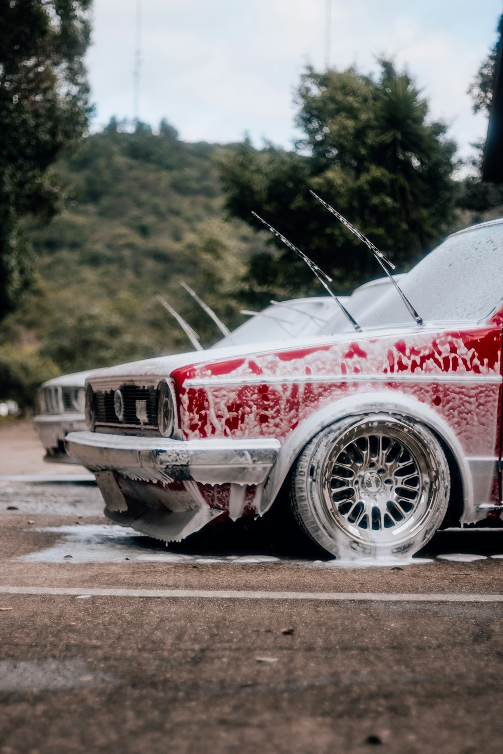 a red and white car parked in a parking lot