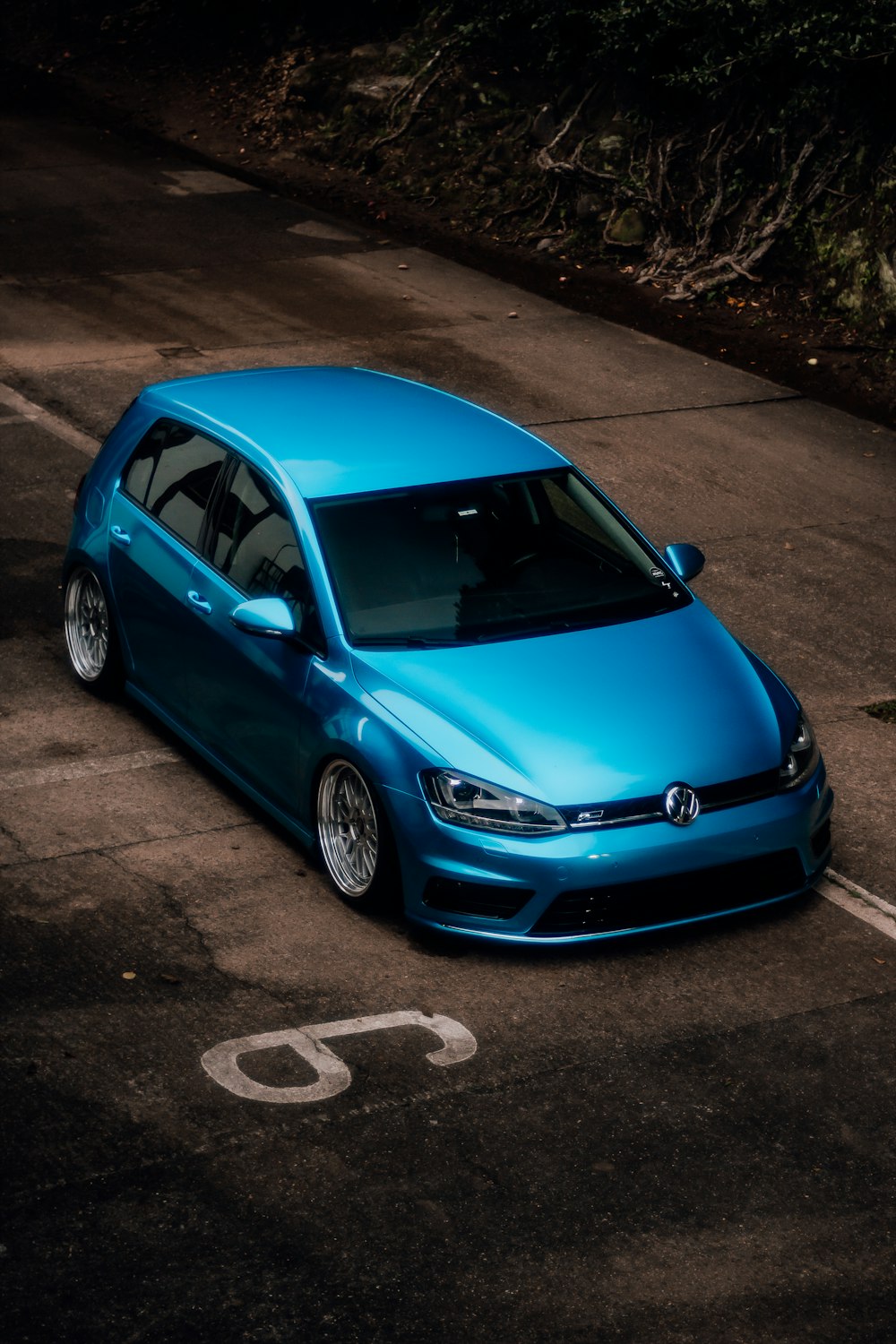 a blue car parked in a parking lot