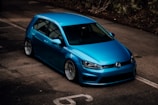 a blue car parked in a parking lot