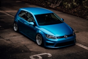 a blue car parked in a parking lot