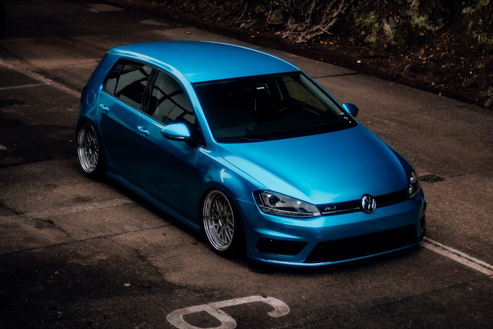 a blue car parked in a parking lot