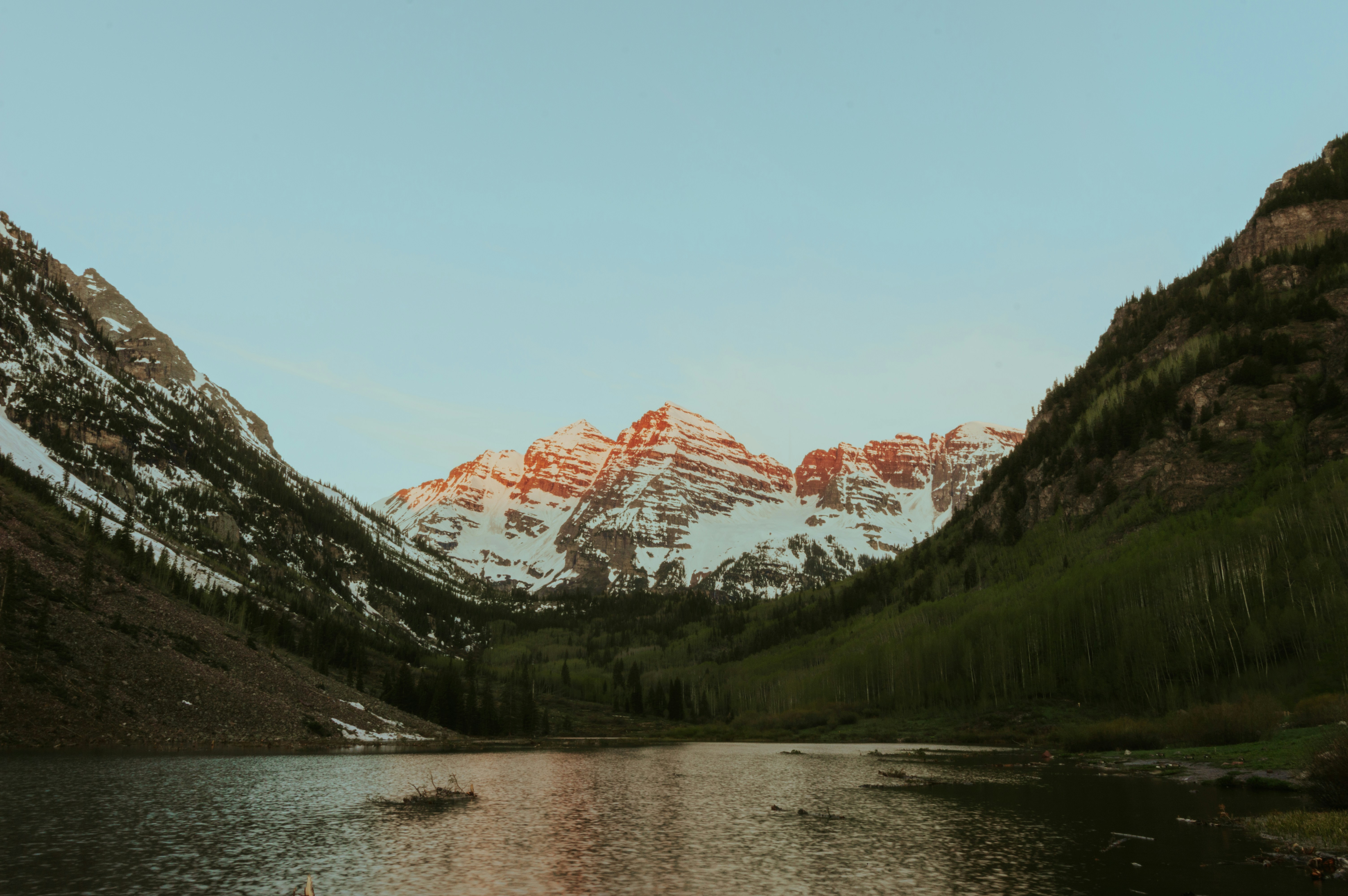 a mountain range with a lake in the foreground
