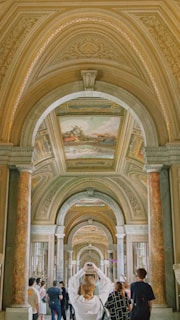 a woman in a white dress standing in a hallway