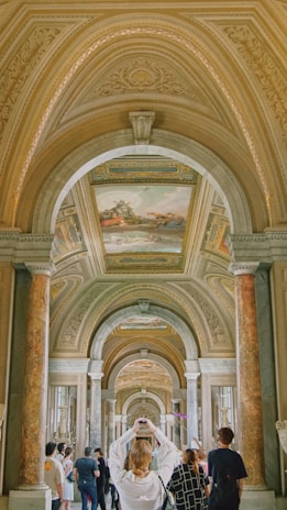 a woman in a white dress standing in a hallway