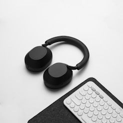 a pair of headphones sitting next to a keyboard