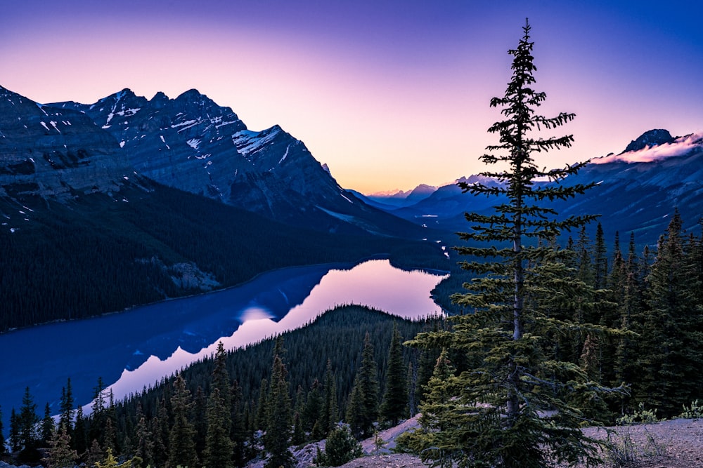 a view of a lake and mountains at sunset