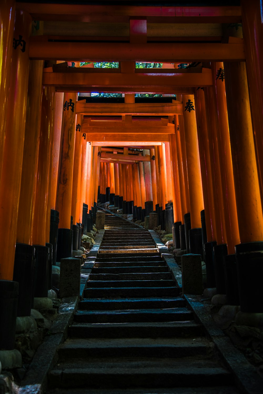 a long hallway with many columns and steps leading up to it