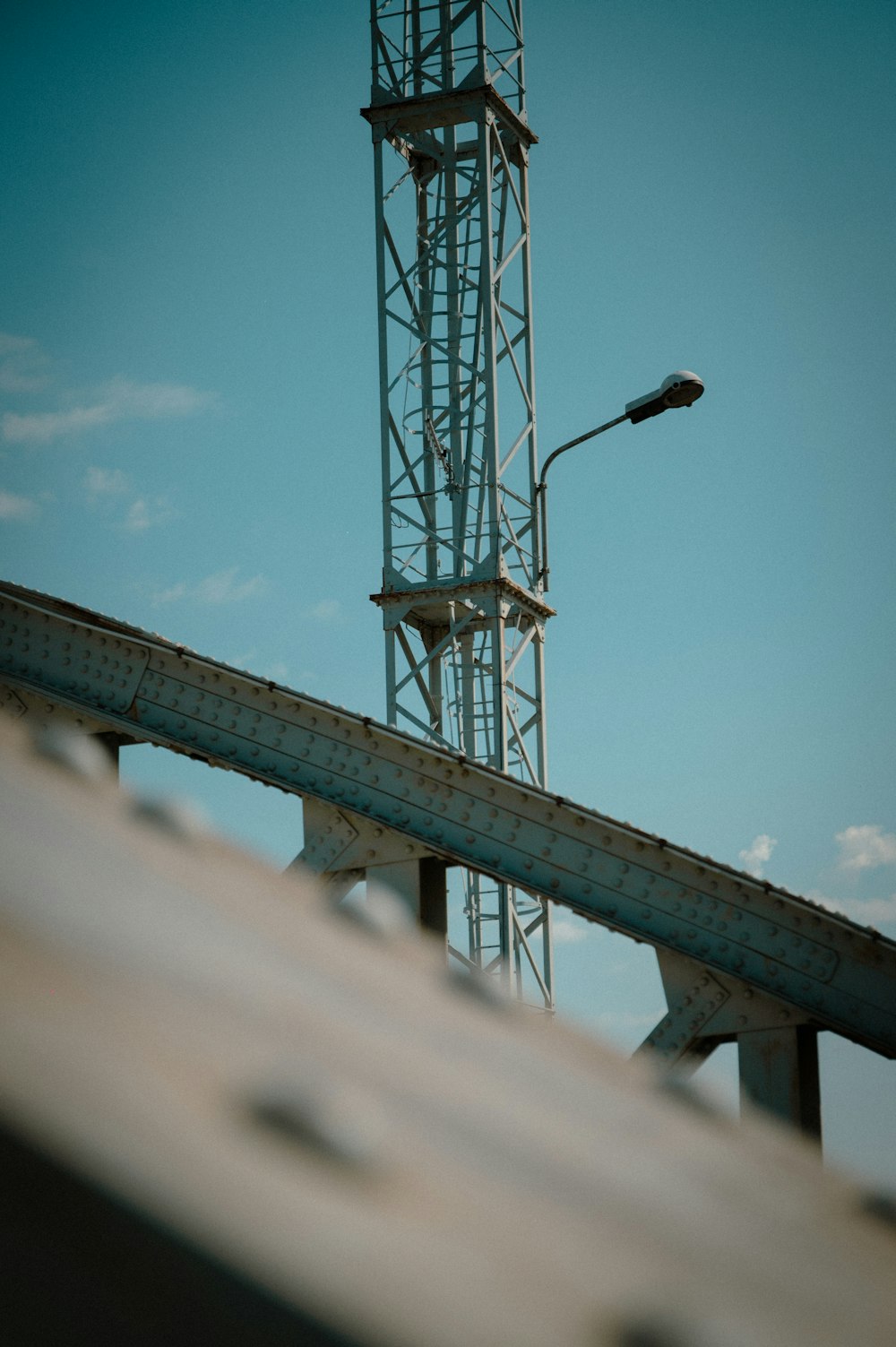 a tall tower with a street light on top of it