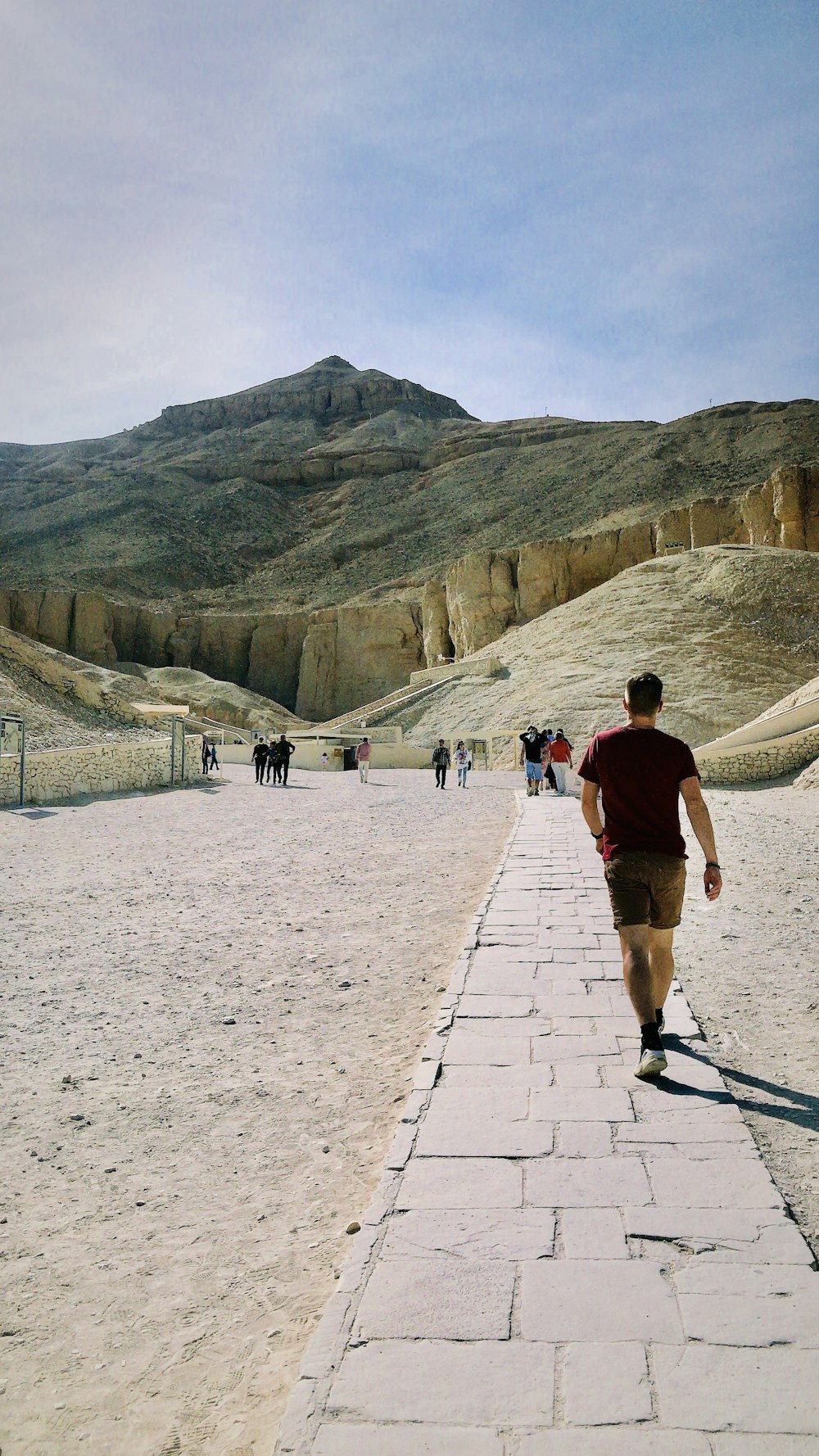 a man walking down a path in the desert