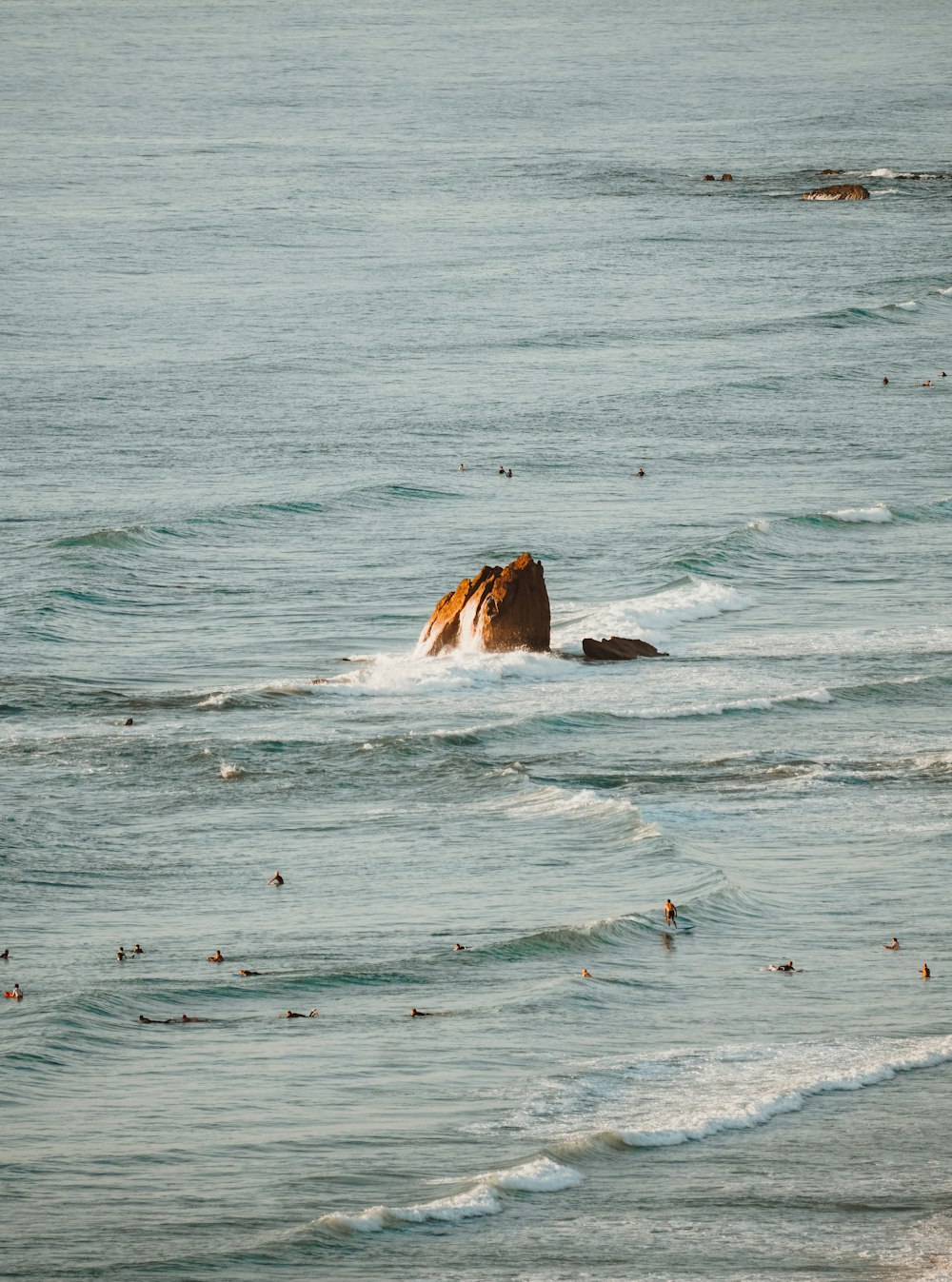 a large rock sticking out of the ocean