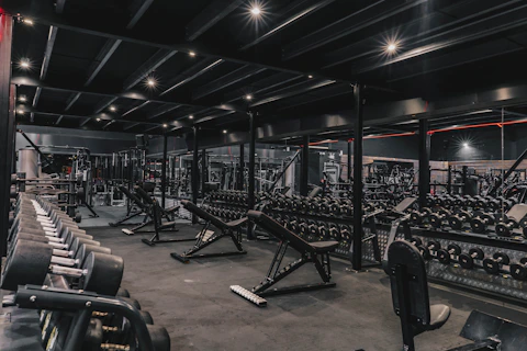 a gym filled with lots of machines and weights