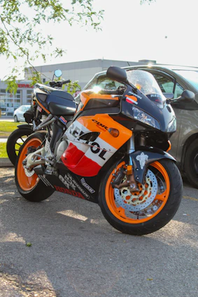 A vibrant pitbike with orange accents parked on a dirt track, reflecting the ok2race brand colors.