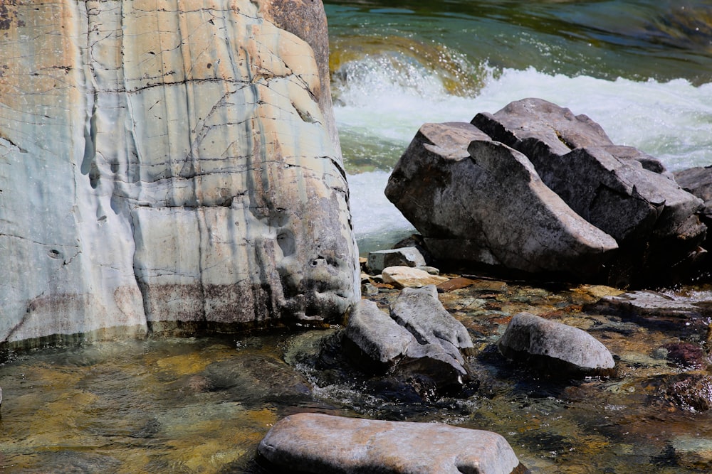 a stream of water with rocks in the foreground