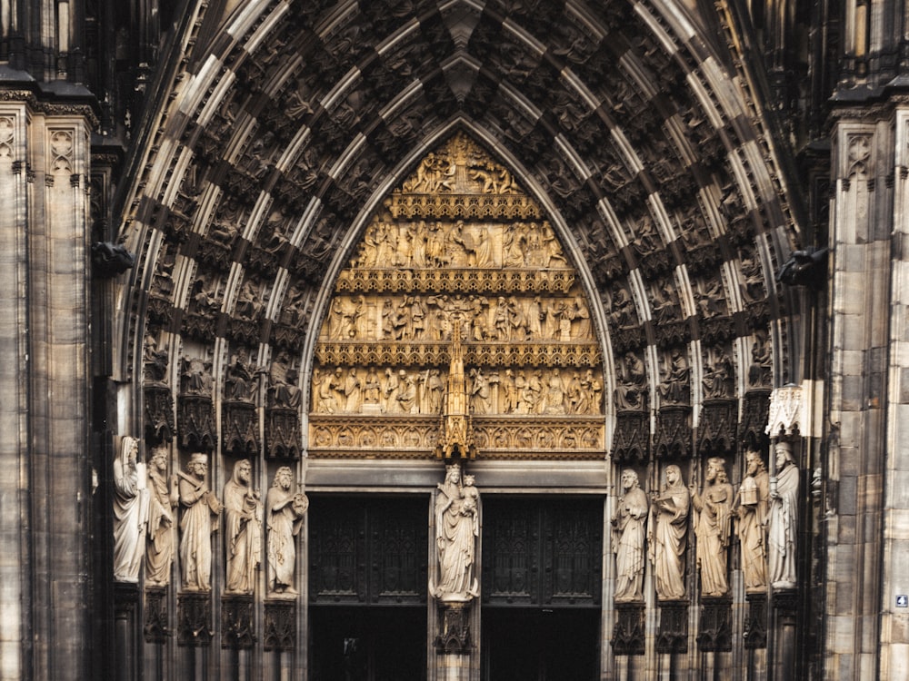 a large cathedral with statues on the side of it